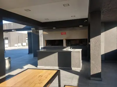 a large kitchen with a counter in a building at Zona residencial frente al lago! in Villa Carlos Paz