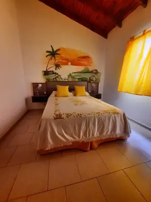 a bedroom with a bed and a painting on the wall at La Dulce in San Javier