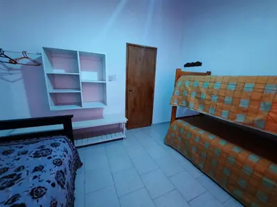 a room with a bed and a wooden door at La Dulce in San Javier