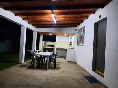 a patio with a table and chairs and a kitchen at La Dulce in San Javier