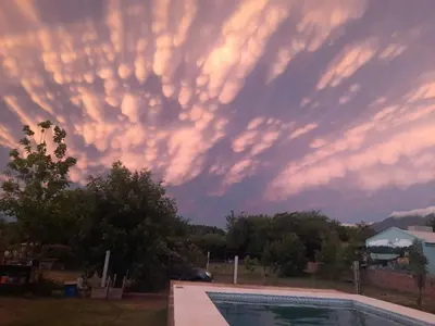 a cloudy sky over a swimming pool at sunset at La Dulce in San Javier
