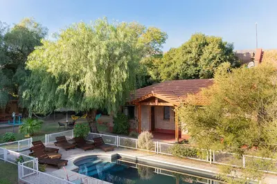 a house with a swimming pool in the yard at La Cuyanita - Complejo de cabañas in Merlo