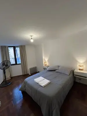 a bedroom with a bed with two towels on it at Departamento EL QUINTANAR 2 in Cordoba