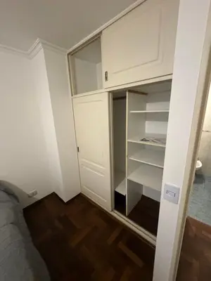 a closet in a room with white cabinets at Departamento EL QUINTANAR 2 in Cordoba