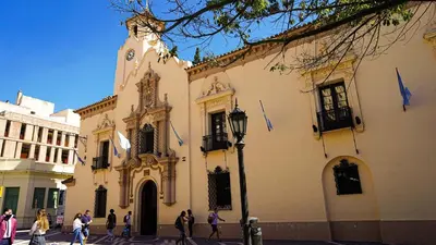 a large white building with a clock tower on a street at Adri in Cordoba