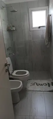 a bathroom with a toilet and a sink and a window at Adri in Cordoba