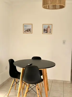 a black table and chairs in a room at Departamento Triana in Cordoba