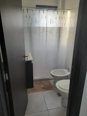 a bathroom with a toilet and a sink at Los Gigantes in Villa Carlos Paz