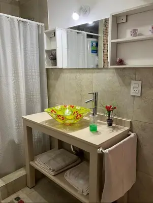 a bathroom with a sink and a bowl on a table at Departamentos del Cerro in Cordoba