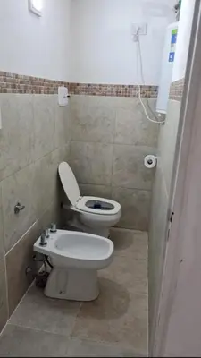 a bathroom with a toilet and a bidet at Departamentos del Cerro in Cordoba