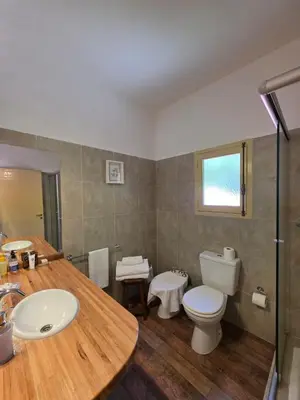 a bathroom with a toilet and a sink at Hotel Loma Bola in La Paz
