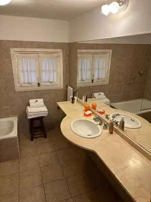 a bathroom with two sinks and a bath tub at Hotel Loma Bola in La Paz