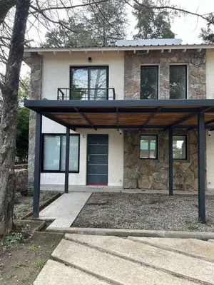 a house with a porch with a roof at Sierras VGB Centro in Villa General Belgrano