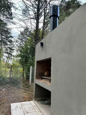 a brick oven with a pizza inside of it at Sierras VGB Centro in Villa General Belgrano
