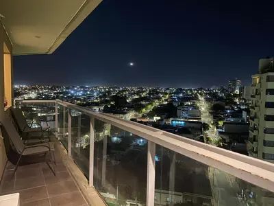 a balcony with a view of a city at night at Buenas vistas apartment in Cordoba