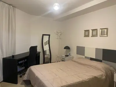 a bedroom with a bed and a desk and a mirror at Buenas vistas apartment in Cordoba