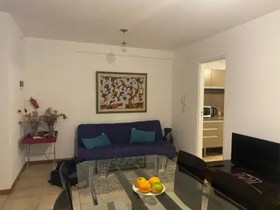 a living room with a blue couch and a table at Buenas vistas apartment in Cordoba