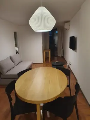 a living room with a wooden table and a couch at Locador Nueva Cordoba 5A in Cordoba