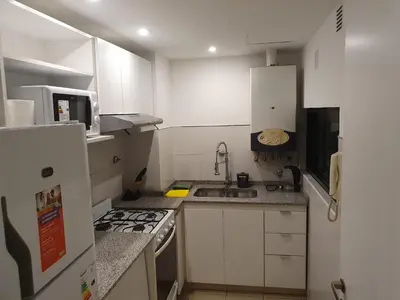 a small kitchen with a stove and a refrigerator at Locador Nueva Cordoba 5A in Cordoba