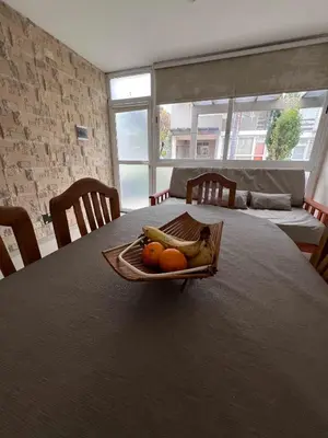 a tray of bananas and oranges on a table at Duplex Independencia in Villa Carlos Paz