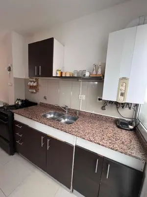 a kitchen with a sink and a counter top at Duplex Independencia in Villa Carlos Paz