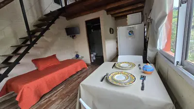 a room with two tables and a bed in a room at La Pasionaria in La Rancherita
