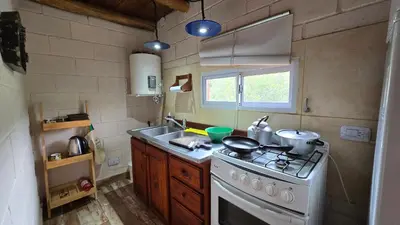 a small kitchen with a stove and a sink at La Pasionaria in La Rancherita