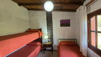a room with two bunk beds and a window at La Pasionaria in La Rancherita