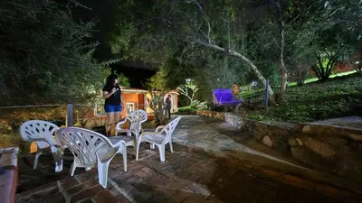 a woman standing next to a group of white chairs at La Pasionaria in La Rancherita