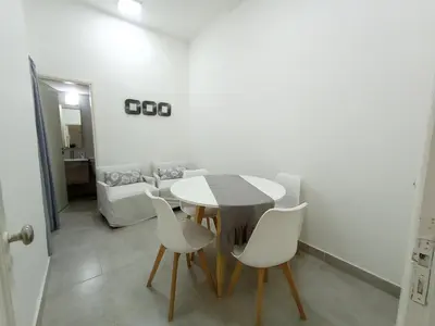 a dining room with a table and white chairs at Artigas Confort - Bienes Reales in Cordoba