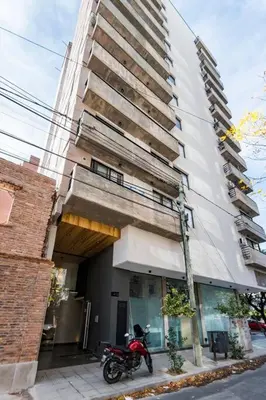 a motorcycle parked in front of a building at Loft en Güemes Piso 9 in Cordoba