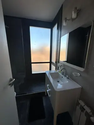 a bathroom with a sink and a large window at villa marina in Villa General Belgrano