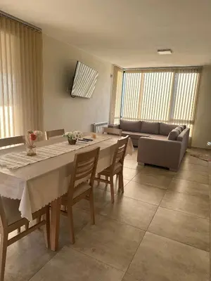 a living room with a table and a couch at villa marina in Villa General Belgrano