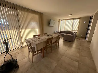a living room with a table and chairs and a couch at villa marina in Villa General Belgrano