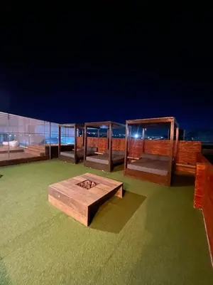 a wooden table on the roof of a building at Costalago Suites Hotel in Villa Carlos Paz