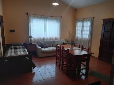 a living room with a table and a couch at Cabañas Aromas Serranos in Alta Gracia