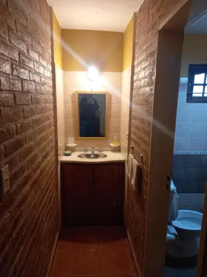 a bathroom with a sink and a mirror at Cabañas Aromas Serranos in Alta Gracia