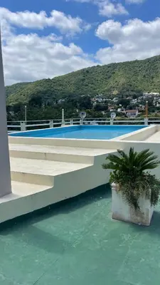 a swimming pool on top of a building at Departamento VILLA CARLOS PAZ 3P in Villa Carlos Paz