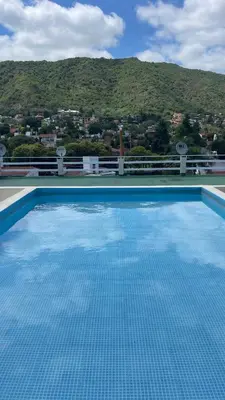 a swimming pool with a view of a mountain at Departamento VILLA CARLOS PAZ 3P in Villa Carlos Paz