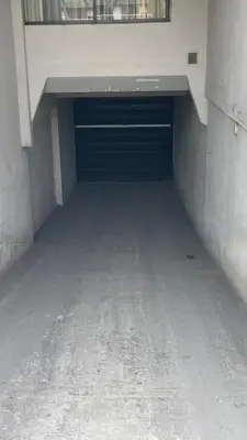 an empty parking garage with a large garage door at Departamento VILLA CARLOS PAZ 3P in Villa Carlos Paz