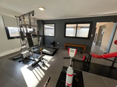 a fitness room with a gym with a treadmill at Edificio Stefano III - Departamento con cochera y amenities a pocas cuadras del centro in Villa Carlos Paz