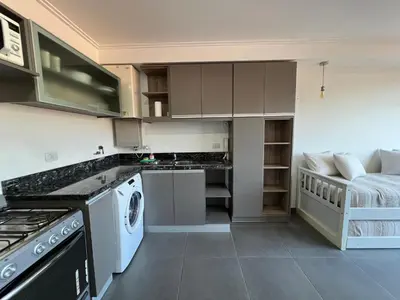 a kitchen with a sink and a stove top oven at Edificio Stefano III - Departamento con cochera y amenities a pocas cuadras del centro in Villa Carlos Paz