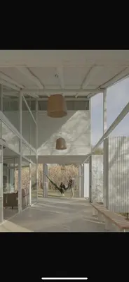 a large white building with a pendant light in it at Casa L in Los Reartes