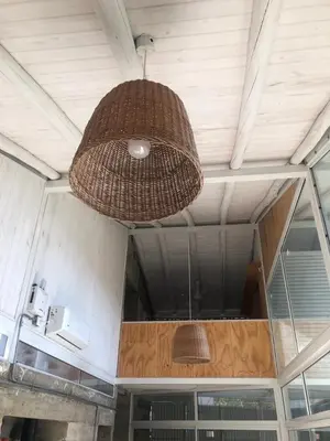 a wicker light hanging from the ceiling of a building at Casa L in Los Reartes