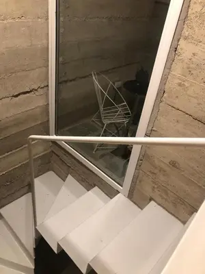 a chair sitting inside of a window next to a table at Casa L in Los Reartes