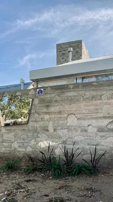 a stone wall with a sign on top of it at Casa L in Los Reartes