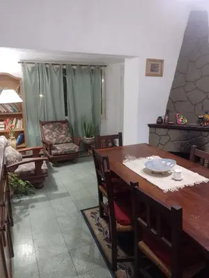 a living room with a wooden table and chairs at Irupé in Villa Carlos Paz