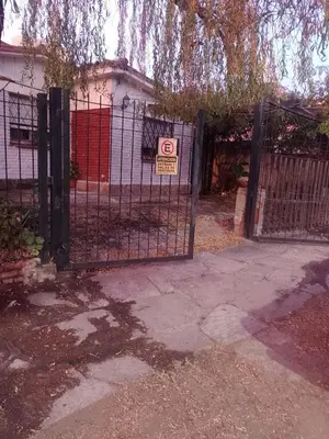a gate with a no parking sign in front of a house at Irupé in Villa Carlos Paz