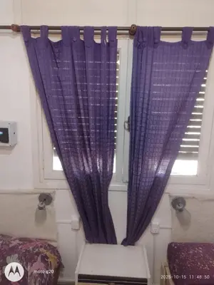 a window with purple curtains in a room at Irupé in Villa Carlos Paz