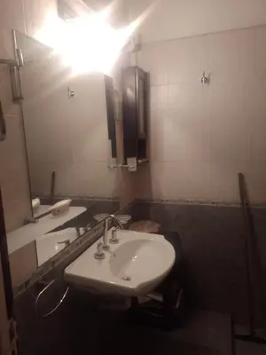 a bathroom with a sink and a large mirror at Irupé in Villa Carlos Paz